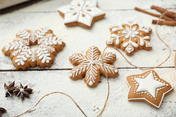 Fototapeta na wymiar Delicious homemade Christmas cookies and flour on wooden table, closeup