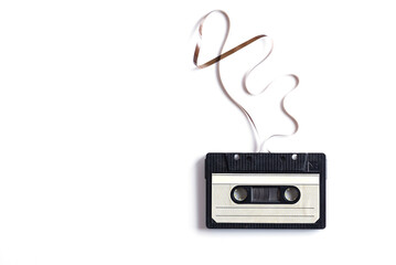 Musical audio cassette with stretched film on a white background. Horizontal orientation, copy...