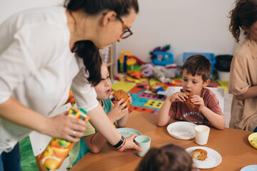 children eat breakfast at child daycare - obrazy, fototapety, plakaty