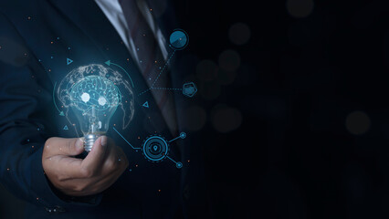 Businessman holding light bulb with brain inside, Creative and innovation inspiration.