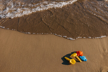 colorful sand child toys on seashore by the sea