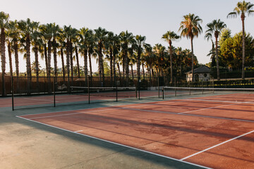 Empty tennis court in sunrise sun light, outdoors.