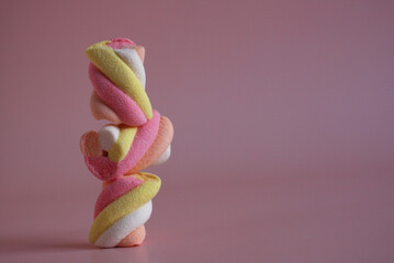 dessert multi-colored air marshmallows on a pink background