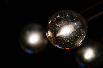 modern light bulbs made of transparent clear glass. sphere lamp hanging on decorative ceiling on dark background