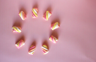 dessert multi-colored air marshmallows on a pink background