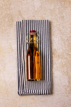 Red Apple Juice in a Bottle on Napkin an Concreet Background Selective Focus Top View