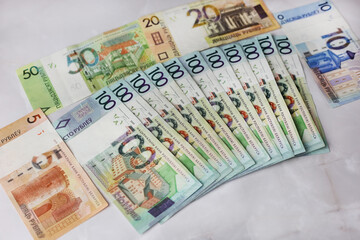 Banknotes in denominations of 100,50,20,10.5 belarusian rubles on an grey background