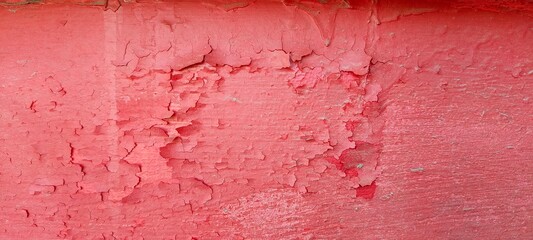 Old red paint on the wall. Abstract background with texture.