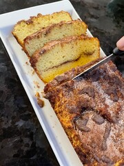 Cinnamon loaf pan being cut into slices 