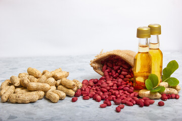 peanut oil, small bottles with peanuts in shell and in organic grains