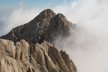 Panoramic view of the summit of Corno Grande in the massif of Gran Sasso d'Italia with fog in Abruzzo