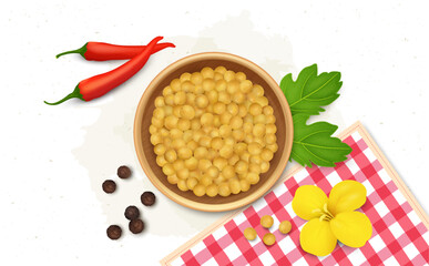 Yellow Mustard Seed in a wooden bowl with mustard green leaves and pepper 