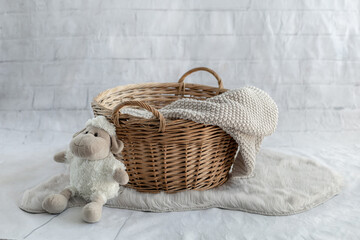 Baby nest with basket and knitted blanket