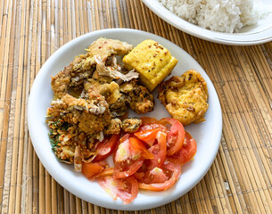 Ayam geprek (smashed fried chicken), fried tofu with slices tomatoes.