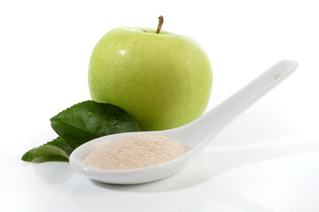 Pectin Powder on a Spoon with a green Apple isolated on white Background