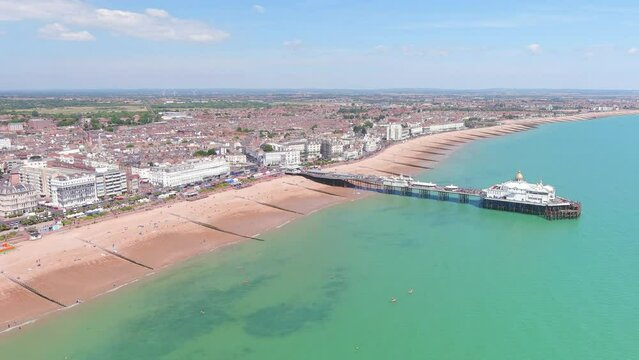 Eastbourne, UK: Aerial view of city in England, wide beach and famous Eastbourne Pier in summer seaside resort by Atlantic Ocean, sunny day - landscape panorama of United Kingdom from above