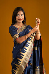 Beautiful Indian girl showing Rakhis on the occasion of Raksha Bandhan.
