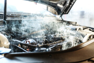 car engine overheating close up. vehicle engine in smoke. short circuit in the car motor. car...