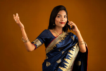 Young beautiful girl or woman holding and using smartphone or mobile or tablet phone