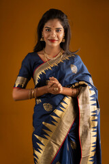 Portrait of a young girl or woman posing on brown background