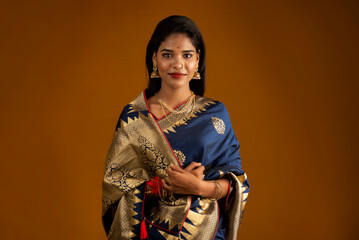 Portrait of a young girl or woman posing on brown background