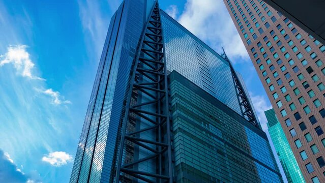 A timelapse of cloud reflecting the building in the business town wide shot panning
