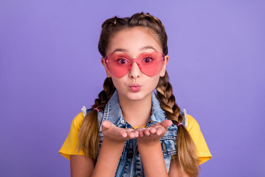 Photo Of Flirty School Blond Girl Blow Kiss Wear Eyewear T-shirt Jeans Vest Isolated On Violet Color Background