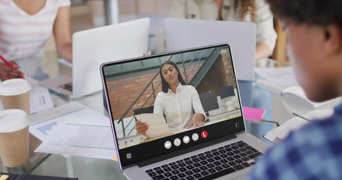 Animation of biracial man having video call on laptop