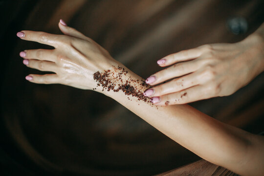 Woman Applying Coffee Natural Body Scrub On Hand