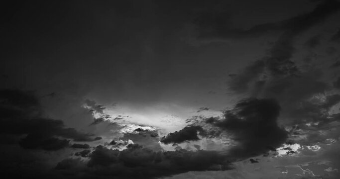 noir Clouds Sky Moving Fast In Dramatic Sky. Black And White Colors Cloudy Sky Fluffy Clouds 4k Hyperlapse. Clouds Illuminated By Sun Move Rapidly Across Sky. Timelapse, Time Lapse, Time-lapse.