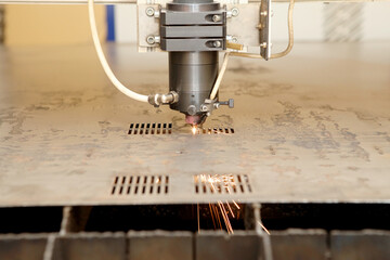 Plasma cutting CNC machine cuts metal material with sparks, industry background aerospace. Robotic...