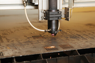 Plasma cutting CNC machine cuts metal material with sparks, industry background aerospace. Robotic...