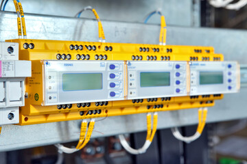Electrician engineer work tester measuring voltage and current of power electric line in electical cabinet control.and wires on relay protection system. Bay control unit. Medium voltage switchgear.