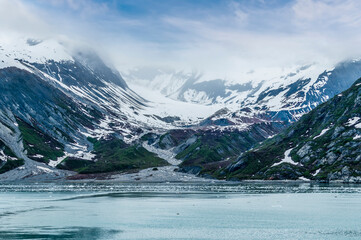 Fototapeta na wymiar A view of snow filled valleys and moraine on the sides of Glacier Bay, Alaska in summertime