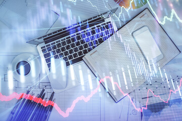 Multi exposure of forex chart drawing over table background with computer. Concept of financial research and analysis. Top view.
