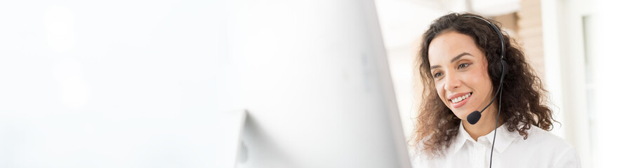 Female call center with headset service support customer by computer. Technical support operator...