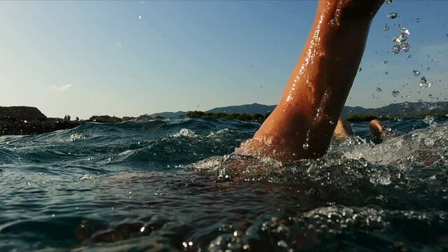 professional swimmer moving through the open water of sea close up slow motion shot