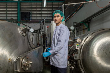 Supervisors supervising the process of beverage at the manufacturing . Man working in food Factory industry