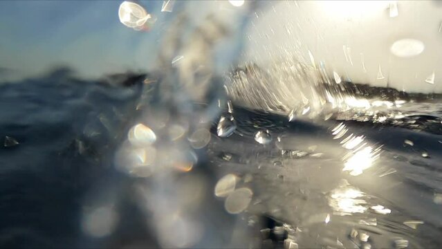 Professional triathlon swimmer practicing freestyle swim at open sea water slow motion shot