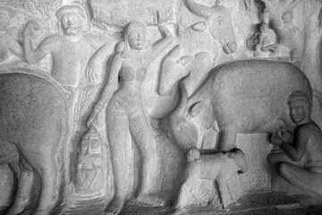 Bull sculpture carved in the monolithic rock cut unfinished ancient cave temples in Mahabalipuram, Tamilnadu. Indian rock art of bas relief animal sculptures at rock cut historical caves in Tamilnadu.