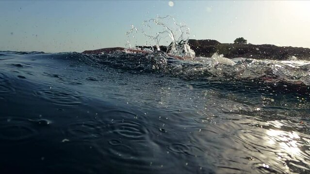 Professional swimmer practicing freestyle swim at open sea water slow motion shot