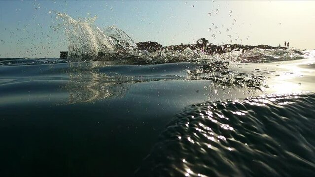 Professional swimmer practicing freestyle swim at open sea water slow motion shot