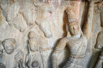 Human rock relief sculptures carved in the rock cut ancient cave temple in Mahabalipuram,...