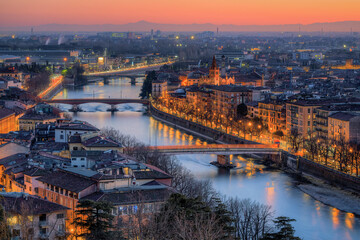 Verona Lungadige, view of the Adige bridges on the southeastern part of the city, photo of February 2022 at sunset at blue hour.