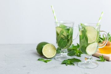 Mojito summer refreshing cocktail with ice and mint. mojito cocktail with lime, lemon and mint in a tall glass with a stick