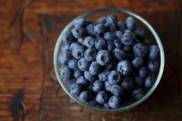 Blueberries in a bawl, fresh berry on the wooden table
