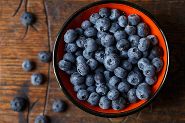 Blueberries in a bawl, fresh berry on the wooden table