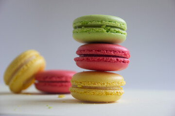 colorful macaroons isolated on a white table and background, stacked macarons, selective focus