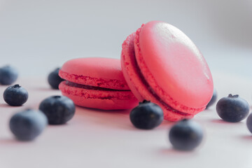 Obraz na płótnie Canvas Strawberry macaroons and blueberries, close-up view, selective focus