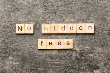 No hidden fees word written on wood block. No hidden fees text on cement table for your desing, Top...